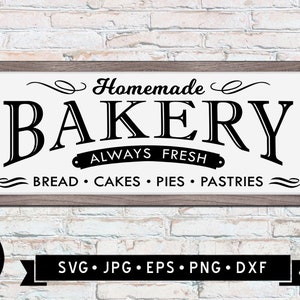 May include: A white sign with a brown frame reads "Homemade Bakery" in a black script font. Below the text is a banner that reads "Always Fresh" in a smaller font. Below the banner is the text "Bread • Cakes • Pies • Pastries" in a smaller font. The sign is on a white brick wall.
