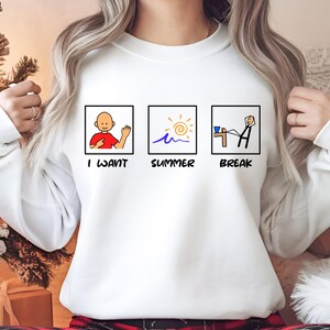 May include: White sweatshirt with a graphic design of three squares. The first square says "I want", the second square says "Summer" and the third square says "Break".