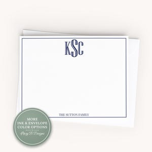 May include: A white rectangular stationery card with a dark blue border, featuring a centered dark blue monogram with the letters KSC and the text THE SUTTON FAMILY printed at the bottom. A circular sage green badge with white text is included.