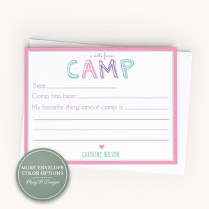 May include: A rectangular stationery card with a pink border featuring the text a note from CAMP in colorful letters. The card includes blank lines for writing a letter, the name CAROLINE WILSON, and a small pink heart. A green circular badge is present.