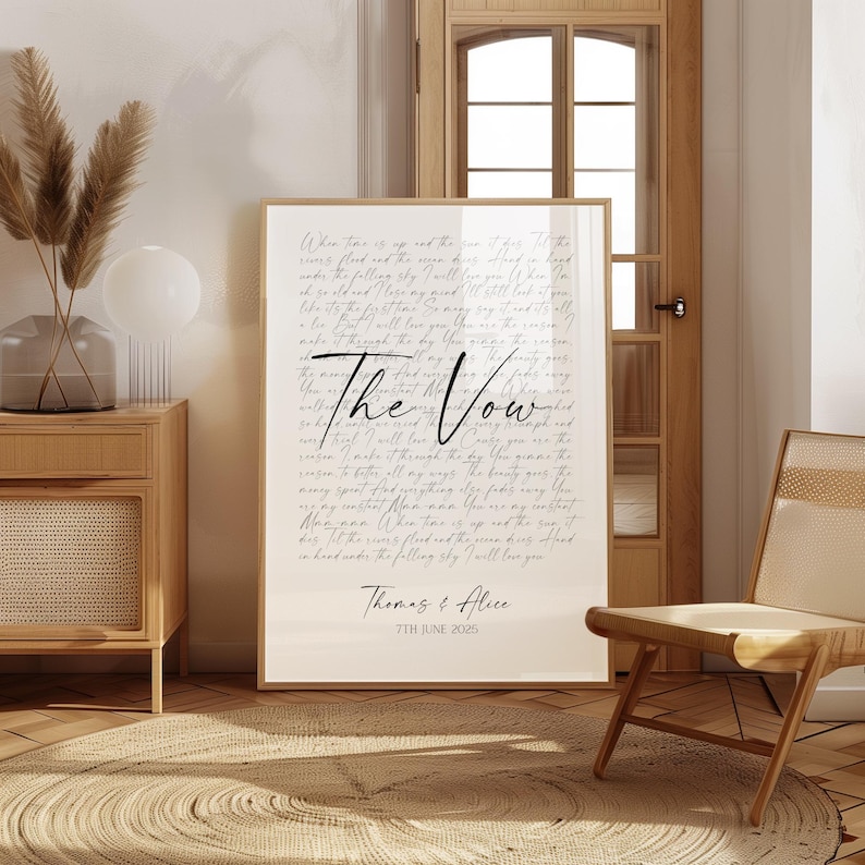 a large framed poster titled "The Vow" with handwritten text, placed in a room with a wooden chair and a woven basket.