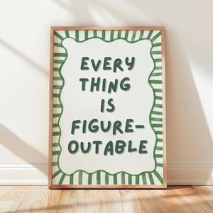 a framed poster with the text "EVERY THING IS FINE-OUT-OF-FIGURE" written in a playful, artistic font.