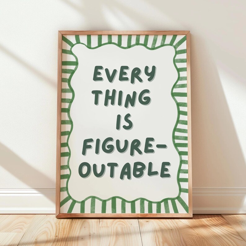 a framed poster with the text "EVERY THING IS FINE-OUT-OF-FIGURE" written in a playful, artistic font.