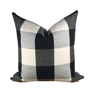 May include: Black and white checkered throw pillow with a soft, textured fabric.