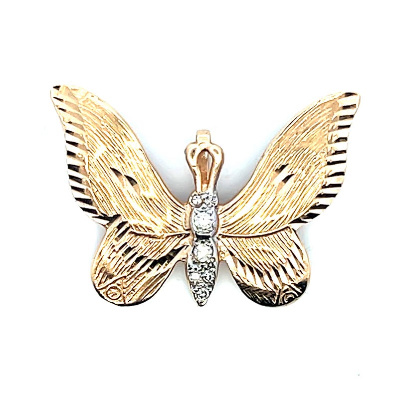 May include: A gold butterfly brooch with diamond detailing. The wings have a textured pattern with etched lines. The body of the butterfly features a row of small diamonds. The brooch is set against a white background.