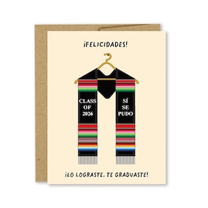 May include: Graduation card with a tan background and a black graduation stole design. The stole has colorful stripes and the words "CLASS OF 2026" and "SÍ SE PUDO". The card also has the text "¡FELICIDADES!" and "¡LO LOGRASTE, TE GRADUASTE!"