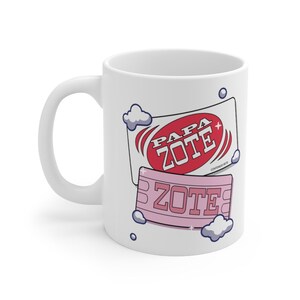 May include: White ceramic mug with a red and pink design featuring the text "Papa Zote" and "Zote" with clouds and a blue circle around the text.