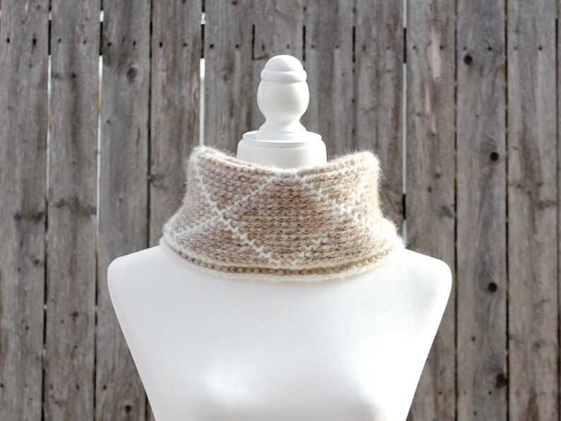 Cream and brown reversible Tunisian crochet cowl, worn folded over on mannequin with reverse side showing from front.