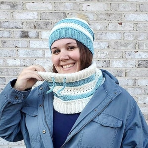 Matching set of cream and blue Persinette cowl and beanie modelled on brown haired woman.