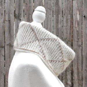Cream and brown reversible Tunisian crochet cowl, worn folded over on mannequin in profile with right side showing.