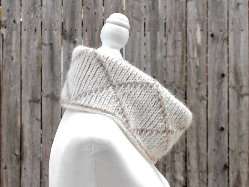 Cream and brown reversible Tunisian crochet cowl, worn folded over on mannequin in profile with right side showing.