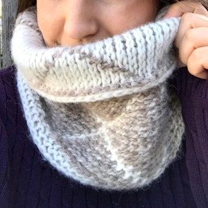 Cream and brown reversible Tunisian crochet cowl, worn with reverse side showing.