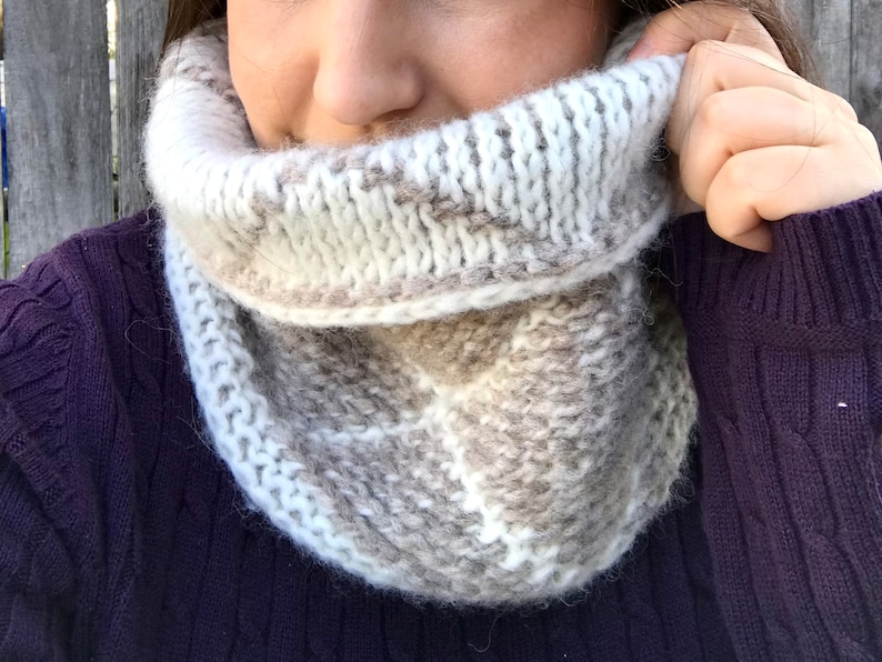 Cream and brown reversible Tunisian crochet cowl, worn with reverse side showing.