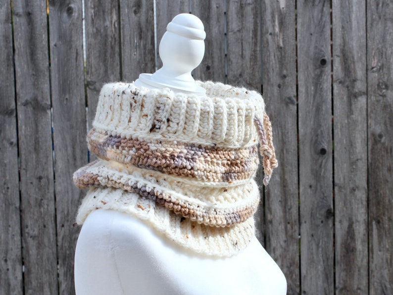 Neutral Cream tweed crochet cowl with drawstring from the side on a mannequin