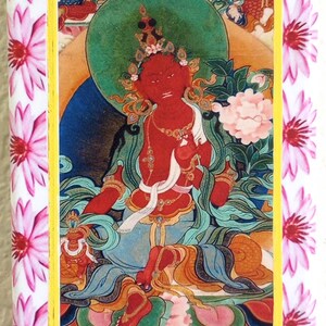 May include: A rectangular item featuring a vibrant illustration of a deity with red skin, adorned with ornate jewelry and a halo. The artwork is framed with a yellow border and surrounded by a white background with pink floral patterns.