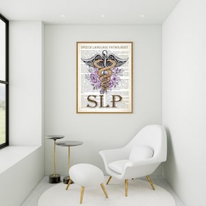 May include: A white room with a white chair and a white ottoman. A framed print with a medical symbol and the text "Speech Language Pathologist SLP" is hanging on the wall.