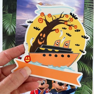 May include: A Halloween-themed Disney Cruise Line sticker featuring a ship sailing past a spooky tree with jack-o'-lanterns and ghosts. The sticker has a banner at the bottom with space for a personalized message.