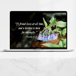 May include: A laptop computer screen displaying a quote about friendship and adversity from Proverbs 17:17. The quote is set against a background of blue and purple flowers.