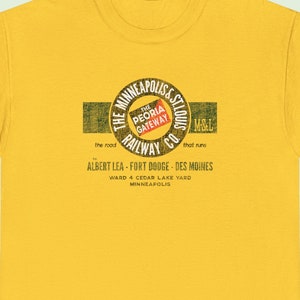 Straight-on image of a train t-shirt featuring Gold Minneapolis & St. Louis Railway logo