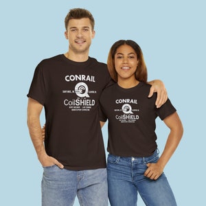 Young happy couple wearing Conrail Brown CR CoilSHIELD shirts, perfect train enthusiast gifts for both