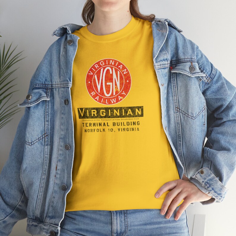 Lifestyle image of a woman in a denim jacket, facing left, wearing the Gold Virginian Railway t-shirt