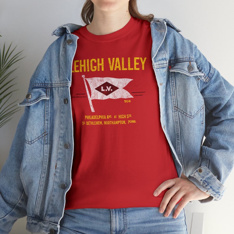 Lifestyle: woman in denim jacket facing left, wearing Red Lehigh Railroad t-shirt