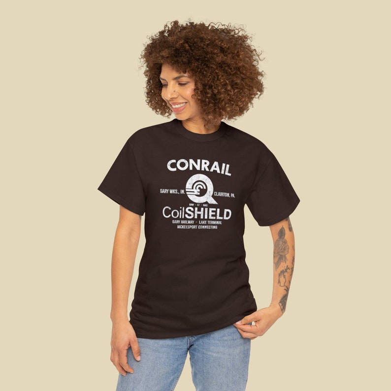 Happy young woman wearing Conrail Brown CR CoilSHIELD shirt, a stylish train enthusiast gift