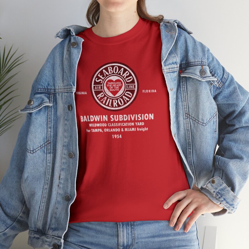 Woman wearing Red Seaboard Air Line Railroad t-shirt, denim jacket over, facing left
