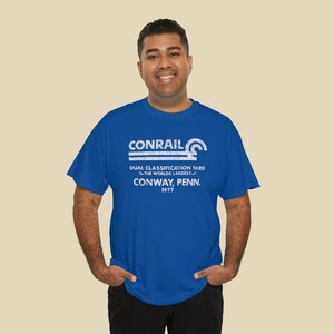 Happily wearing Conrail Royal Blue CR shirt, a fashionable choice for train enthusiasts in their early 30's