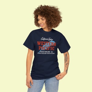 Happy young woman wearing Navy Western Pacific Railroad t-shirt, looking to our left