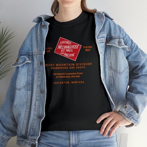 Woman wearing Black Milwaukee Road t-shirt with denim jacket over, a trendy train enthusiast gift