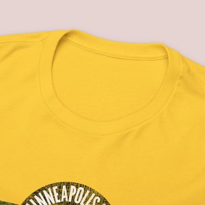 Closeup image of front t-shirt collar neck ring on train t-shirt with Gold Minneapolis & St. Louis Railway logo