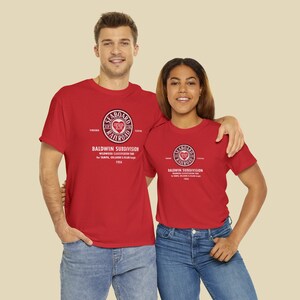 Young happy couple looking at us, both wearing Red Seaboard Air Line Railroad t-shirts