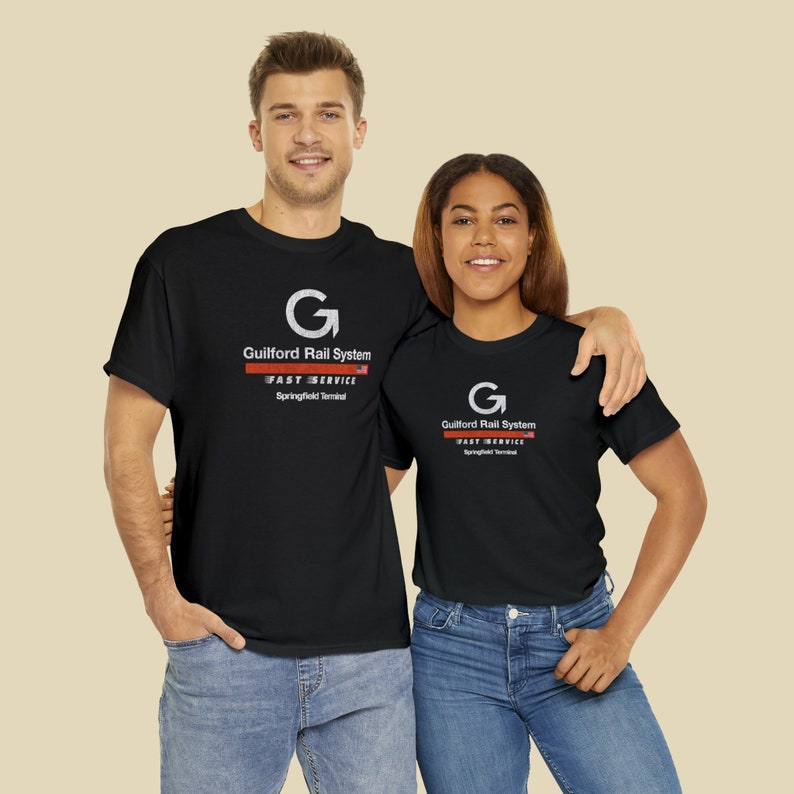 Happy young couple wearing Black Springfield Terminal Railway T-Shirts, looking at us