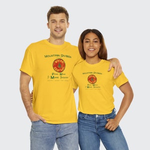 Young happy couple looking at us, both wearing Yellow or Green Maine Central Railroad t-shirt