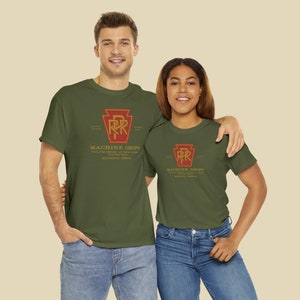 A happy young couple wearing Olive Pennsylvania Railroad train t-shirts for train enthusiasts