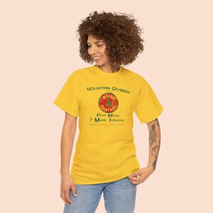 Young woman looking left, happy wearing Yellow or Green Maine Central Railroad t-shirt