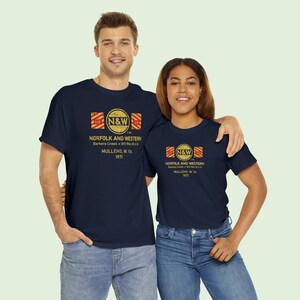 Happy young couple wearing Navy Norfolk and Western Railway t-shirts. Train lovers