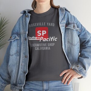 Lifestyle image of woman wearing Charcoal Southern Pacific Railway train shirt with denim jacket