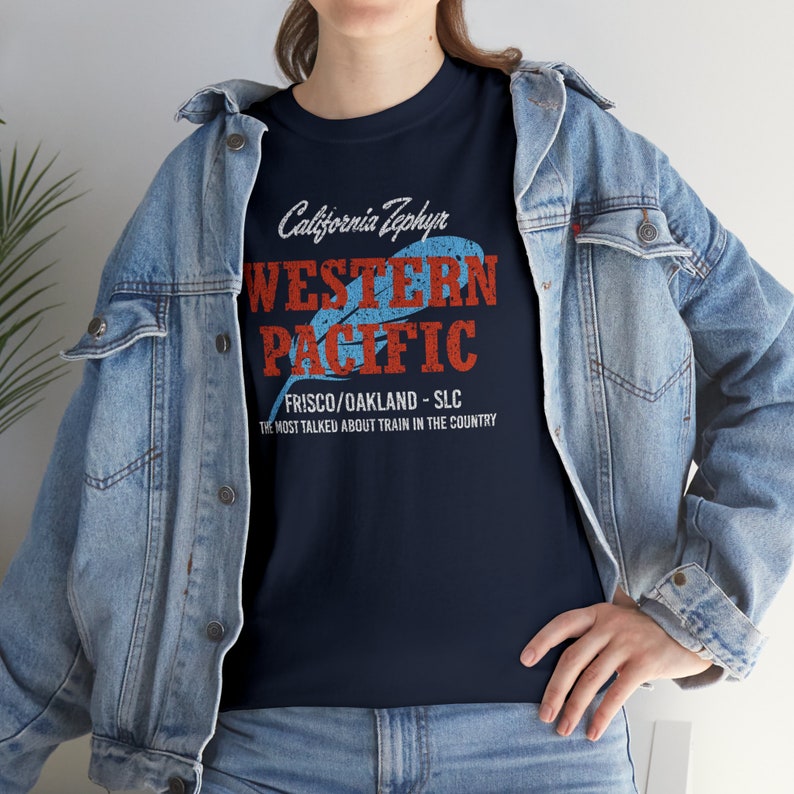 Lifestyle image with woman wearing Navy Western Pacific Railroad t-shirt, denim jacket over, facing left