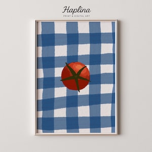 May include: Framed art print featuring a red tomato atop a blue and white checkered tablecloth design. The artwork is framed in a gold-colored frame. The text "Haplina PRINT & DIGITAL ART" is at the top of the image.