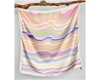 May include: A square silk scarf featuring a wavy, multi-coloured pattern of soft pink, pale yellow, light blue, sage green, and deep purple horizontal stripes. The scarf is finished with a clean white border along all four edges of the fabric.