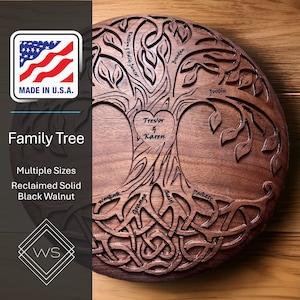 May include: A round, dark brown wooden family tree plaque with a heart in the center that says "Trevor & Karen". The tree has branches with names like "Justin", "Kaitlyn & Hollis Gunter", and "Grange". The roots are intricately carved and the plaque says "Family Tree" and "Made in U.S.A.".