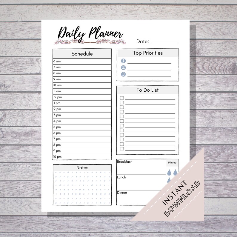 May include: A printable daily planner with sections for schedule, top priorities, to do list, notes, breakfast, lunch, dinner, and water. The planner has a floral design and is in black and white.