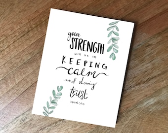 May include: White card with black calligraphy that reads "Your strength will be in keeping calm and showing trust. Isaiah 30:15". The card is decorated with green watercolor leaves.