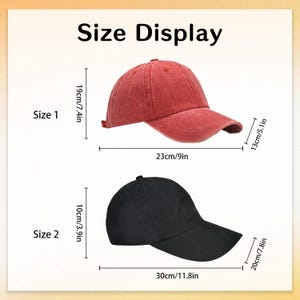 May include: Image showing size details for two baseball caps. The top cap is red, measuring 9 inches wide, 7.4 inches high, and 5.1 inches deep. The bottom cap is black, measuring 11.8 inches wide, 3.9 inches high, and 7.8 inches deep. Text on the image reads "Size Display".
