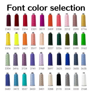 May include: A color chart displaying a selection of thread spools in various colors. The text "Font color selection" is at the top. Each spool is labeled with a unique number, ranging from dark red to white.
