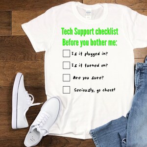 May include: White t-shirt with a green checklist that reads "Tech Support checklist Before you bother me:" with four checkboxes and the following text: "Is it plugged in?", "Is it turned on?", "Are you sure?", and "Seriously, go check!"