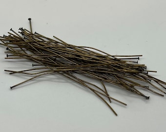 May include: A pile of gold-colored head pins, used for jewelry making and crafts.