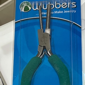 May include: Green handled pliers with a silver metal head. The pliers are labeled "Wubbers" and are packaged on a blue background with the text "...Made to Make Jewelry".